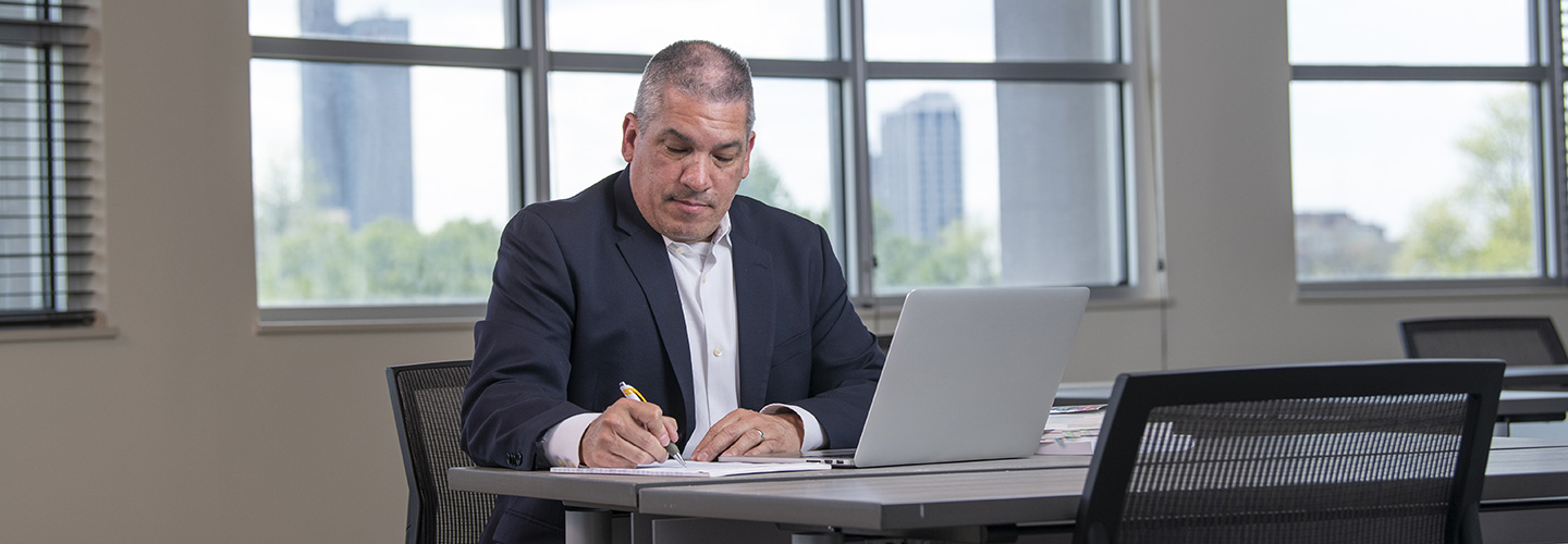 doctoral student working on a laptop